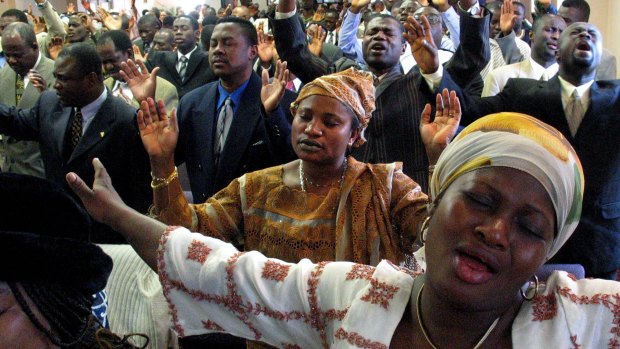 Migrants from Africa fill the Church of the Pentecost in the Bronx on Palm Sunday, 2004. 