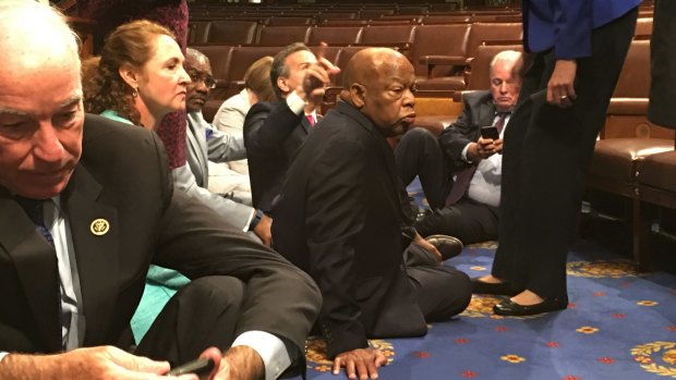 Democrat members of Congress, including Representatives John Lewis (centre) and Joe Courtney participate in sit-down protest seeking a  vote on gun control measures.