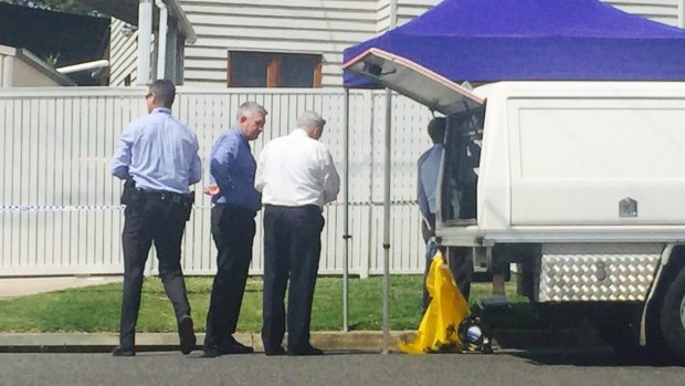 Police at the Kedron home where the girl was found dead in September.