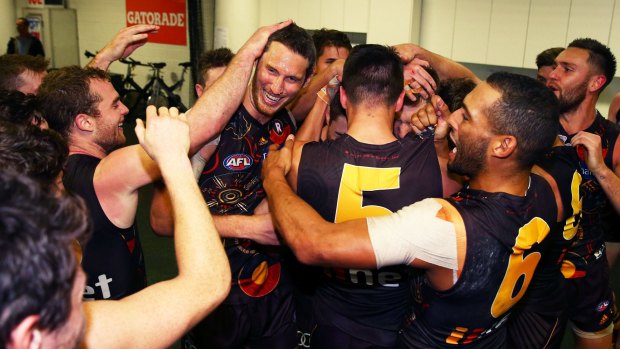 The Hawks' Ty Vickery celebrates with teammates after the round 10 win against the Sydney Swans.