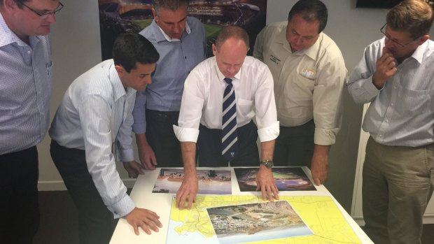Premier Campbell Newman looks over plans for a new stadium in Townsville on Wednesday.
