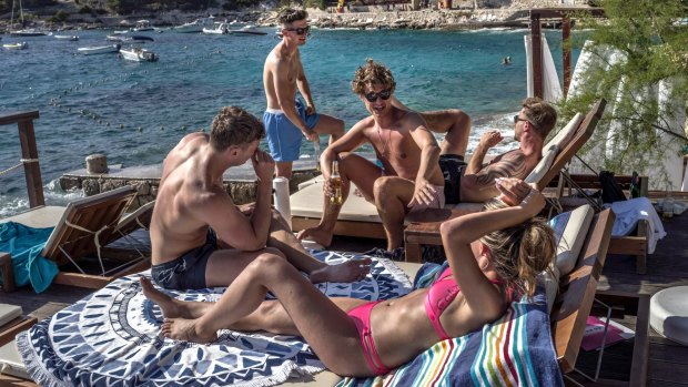A group of tourists at the popular Hula Hula beach bar on Hvar, Croatia.