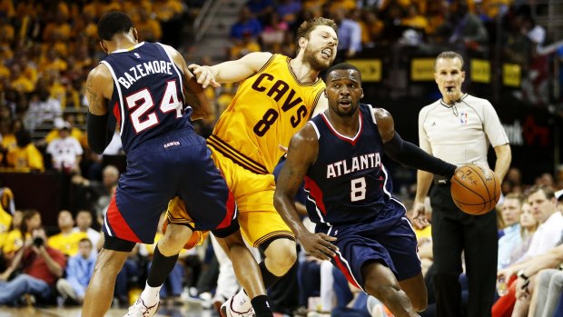 Moving violation: Atlanta's Kent Bazemore hits Matthew Dellavedova with an illegal screen as Shelvin Mack gets clear.