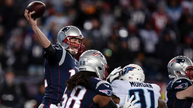Tom Brady passes under pressure from Tennessee Titans.