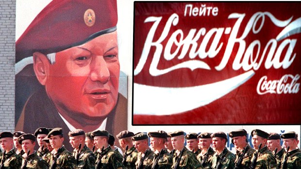 Interior Ministry troops march in front of a billboard depicting former Russian president Boris Yeltsin in 1999. The Russian market is now worth some $9.9 billion to the soft-drink maker.