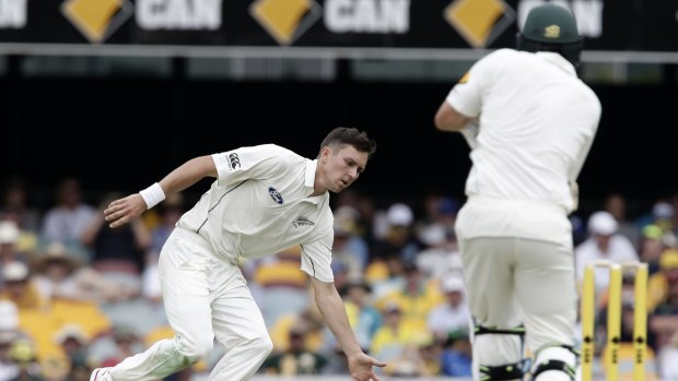 Tough day in the field: Trent Boult gets down in time to block a drive from Joe Burns.