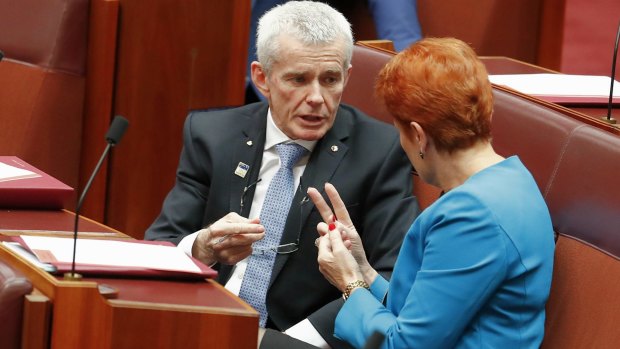 One Nation senator Malcolm Roberts and leader Pauline Hanson in discussion in the Senate.