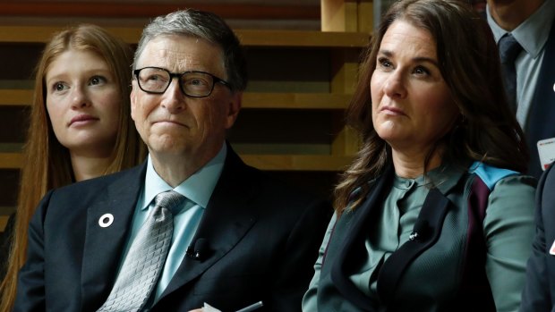 Bill Gates, left, and his wife, Melinda Gates, listen to former US president Barack Obama speak during the Goalkeepers Conference at the UN on Wednesday.