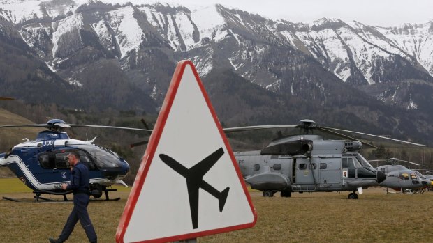 Rescue helicopters from the French authorities in front of the Alps during a rescue operation next to the crash site of a Germanwings Airbus A320.
