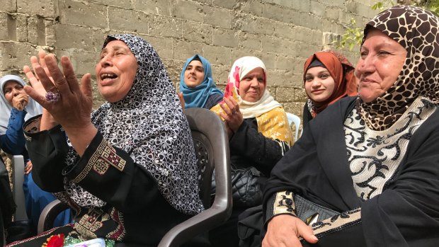 Older women sing at the Aged Care Association in Gaza, a country where many women face domestic abuse or economic uncertainty.