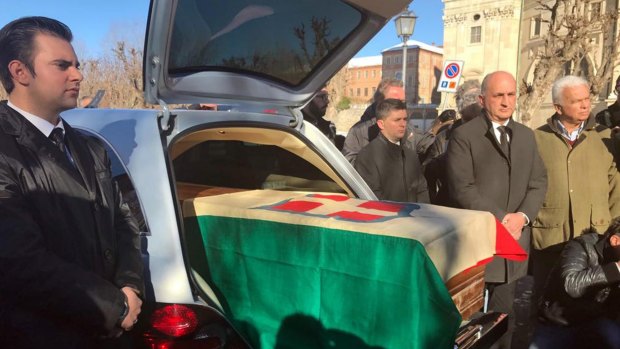 The coffin with the remains of Italy's King Victor Emmanuel III, draped in a flag with the House of Savoy crest, arrives at the Sanctuary of Vicoforte, on Sunday.