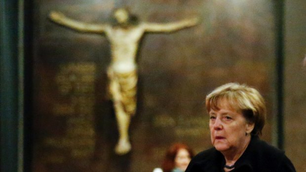German Chancellor Angela Merkel arrives to sign the condolence book at the Kaiser Wilhelm Memorial Church in Berlin.