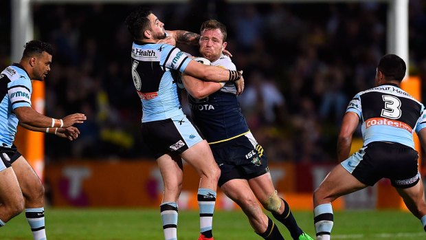 Monstered: Cowboys forward Gavin Cooper charges into Cronulla five-eighth Jack Bird.