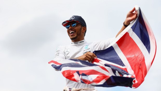 Patriotic: Lewis Hamilton celebrates his win at Silverstone.