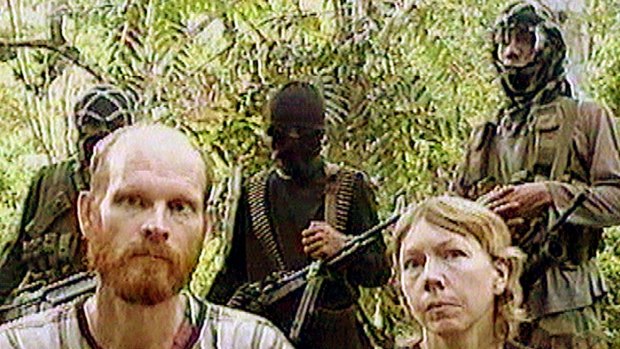 Long history of hostage-taking ... US missionaries Martin and Gracia Burnham are guarded by Abu Sayyaf Islamists on March 7, 2002.