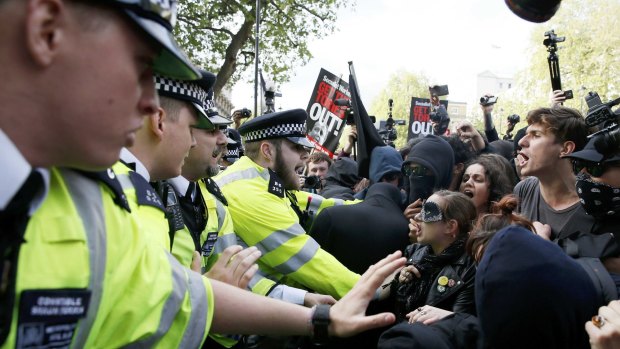 Protesters and police face off at the gates of Downing Street on Saturday.