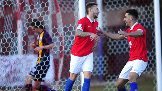 Double strike: Canberra FC striker Thomas James celebrates his second goal with team-mate Josip Jadric in Sunday's 3-0 win against the FFA Centre of Excellence.
