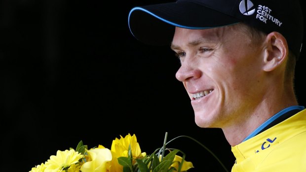 Winning smile: Race leader Chris Froome enjoys another moment on the podium after stage 17.