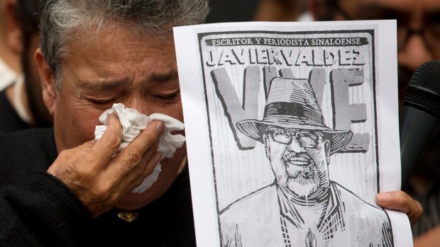 Maria Herrera, a mother who became active in the search for Mexico's missing people after four of her sons disappeared, weeps after speaking about murdered journalist Javier Valdez during a protest on Tuesday.