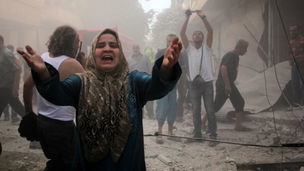 A Syrian woman mourns following an air strike by Assad government forces on the al-Mowasalat neighbourhood of the northern Syrian city of Aleppo on September 20.