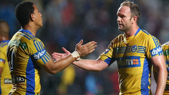 Big upset: Will Hopoate and David Gower of the Eels celebrate victory at Brookvale. 