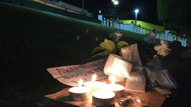 A tribute left outside Dreamworld's front gate on Tuesday night. 