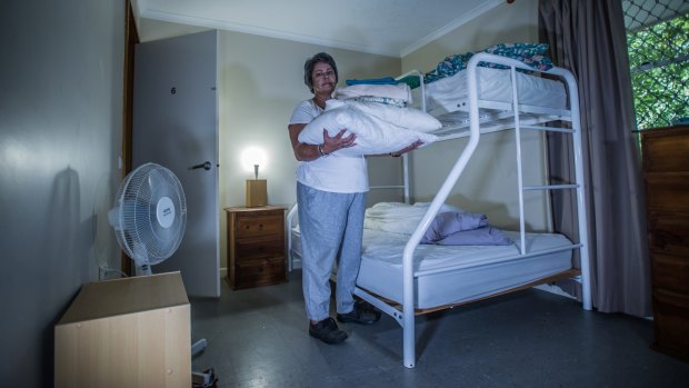 Robyn prepares a room at the refuge, vacated just the day before. In 24 hours, another woman will find sanctuary here.