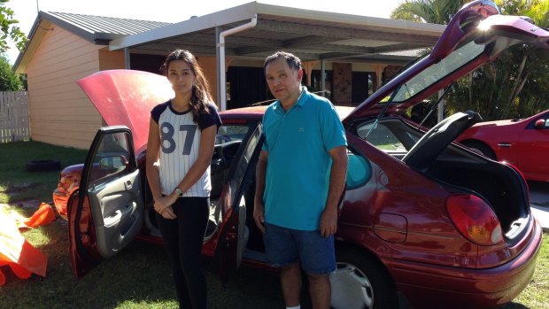 Jasmine Reyes and her father Carlos Reyes in Major Street, Deception Bay: 'We've never had flooding here before.'