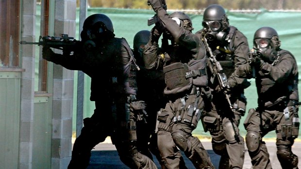 Members of the Tactical Assault Group storm a house during a counter-terrorism demonstration at Sydney's Holsworthy Army Base in a file photo.