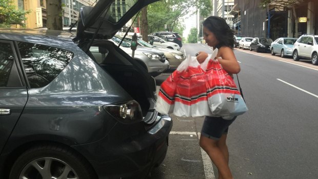 Michelle Barnard-Marks loads her car with her Boxing Day shopping bags.