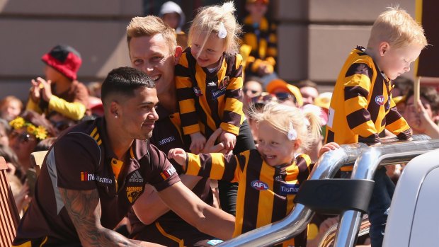 Grand feeling: Hawks Sam Mitchell and Bradley Hill with Sam's children in the 2014 grand final parade. 