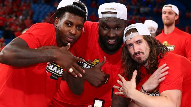 Wildcats' Casey Prather, Nate Jawai and Greg Hire display their rings after winning the NBL championship.