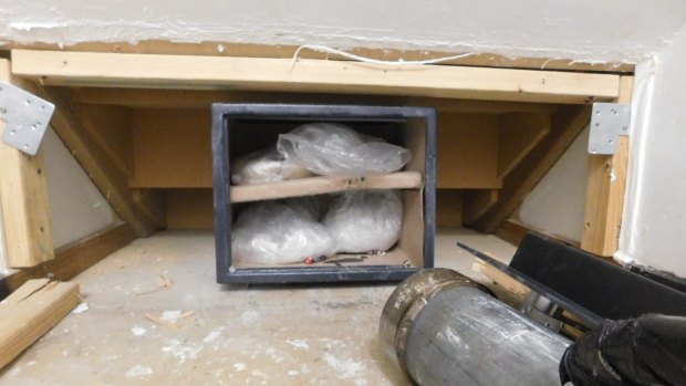 ACT police say they found ice and heroin with a combined street value of over $2 million in this safe hidden behind a false wall.