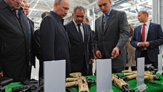 Russian President Vladimir Putin, second left front, visits a display of rifles at the Kalashnikov factory last year.
