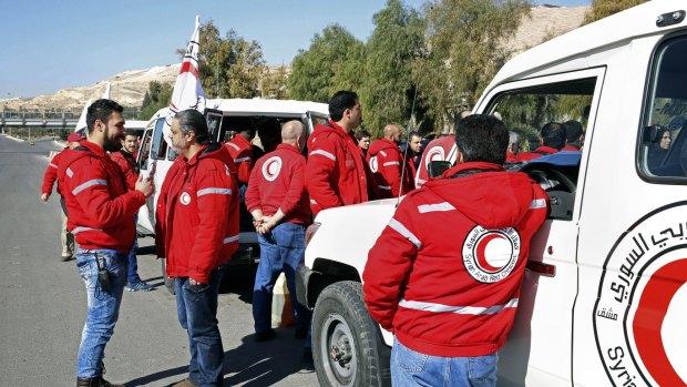 Staff from the Syrian Arab Red Crescent get ready to accompany a convoy of humanitarian aid into the government besieged rebel-held towns of Madaya, al-Zabadani and al-Moadhamiya in the Damascus countryside.