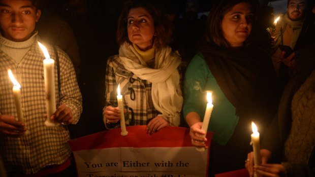 Undeterred: A vigil outside Islamabad's Red Mosque. Its imam has refused to condemn the attack.