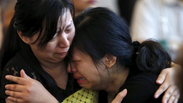 A family member of a passenger on the capsized ship Eastern Star cries at a government briefing.