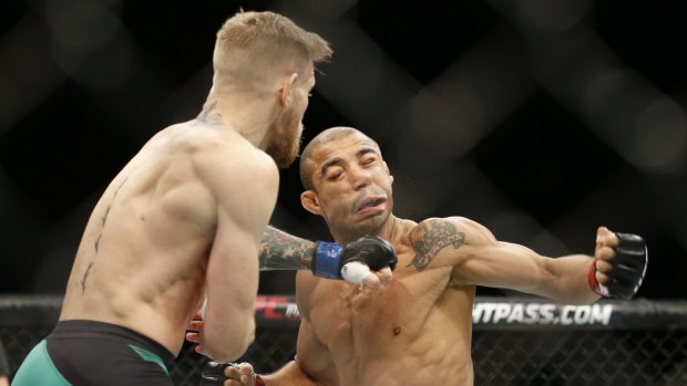 McGregor sends Jose Aldo to the floor with a perfectly timed punch. 