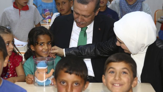 Turkey's President Recep Tayyip Erdogan and his wife Emine with Syrian refugee children last month at the Midyat refugee camp in south-eastern Turkey.