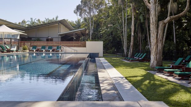 The 25-metre pool is surrounded by cabanas and a rainforest backdrop.