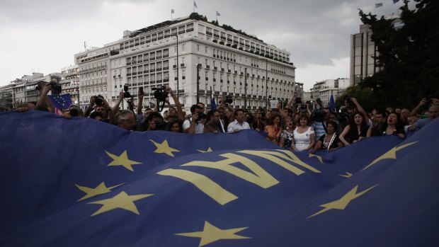 Protesters raise a giant EU flag during a demonstration in Athens.
