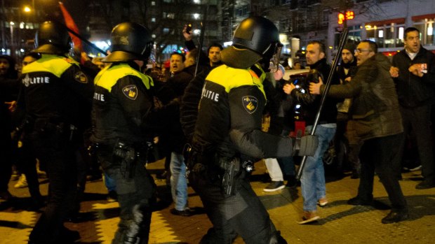Dutch riot police battle pro-Erdogan demonstrators  outside the Turkish consulate in Rotterdam on Sunday.