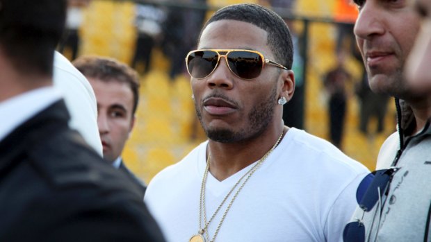 Police have arrested Nelly (pictured) after a woman said he raped her in a town outside Seattle.