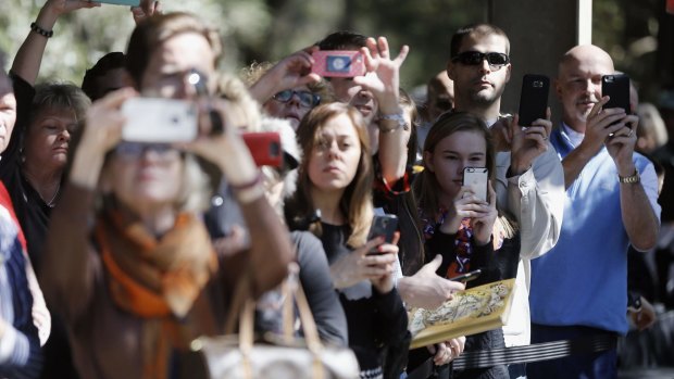 Attendees take photos of Republican presidential candidate Senator Marco Rubio on Tuesday.
