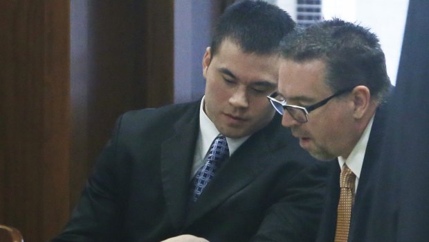 Daniel Holtzclaw, left, talks with his lawyer, Scott Adams, right, in a courtroom in Oklahoma City on Monday.