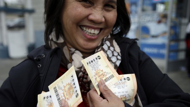 Zaida Cobangbang, of Union City, California, shows her Powerball tickets shortly after buying them on Saturday.