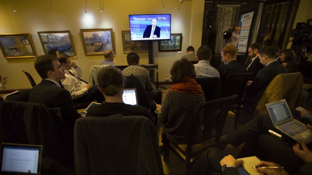 Journalists watch as Mr Putin speaks during his highly choreographed annual call-in show.