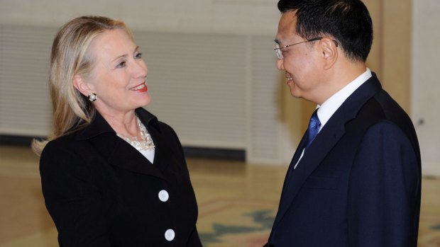 Then US Secretary of State Hillary Clinton, left, shakes hands with then Chinese Vice Premier Li Keqiang in Beijing in 2012.
