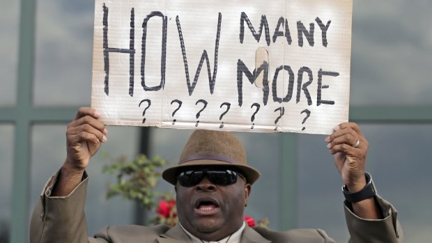 A protester holds a sign after the shooting death of Walter Scott in South Carolina in April.