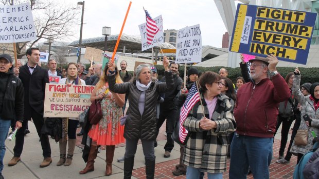 Indivisible supporters rally in Balitmore in February.